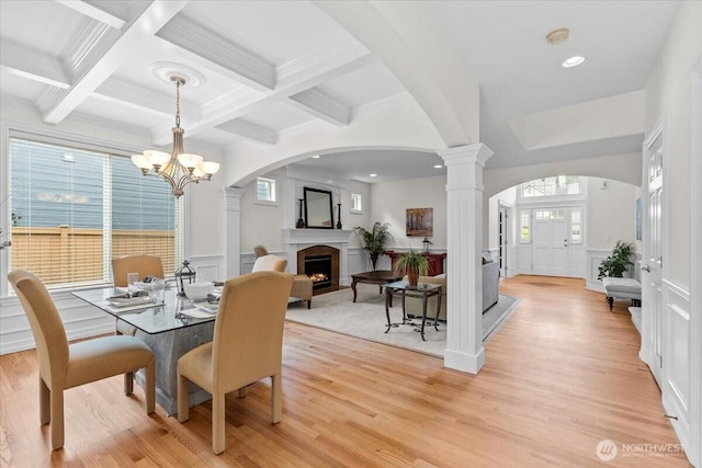 27546 254th Way SE, Maple Valley, WA 98038 - dining space with a decorative wall, beamed ceiling, light wood-style floors, a chandelier, and coffered ceiling