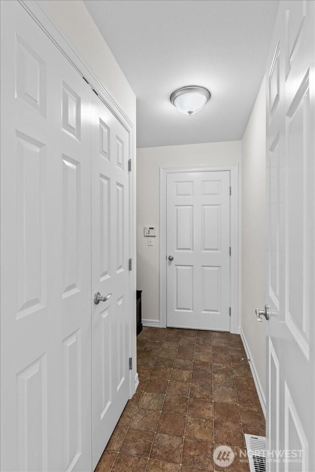 27546 254th Way SE, Maple Valley, WA 98038 - hallway with baseboards and stone finish flooring