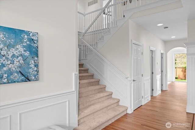 27546 254th Way SE, Maple Valley, WA 98038 - staircase with arched walkways, wood finished floors, and recessed lighting