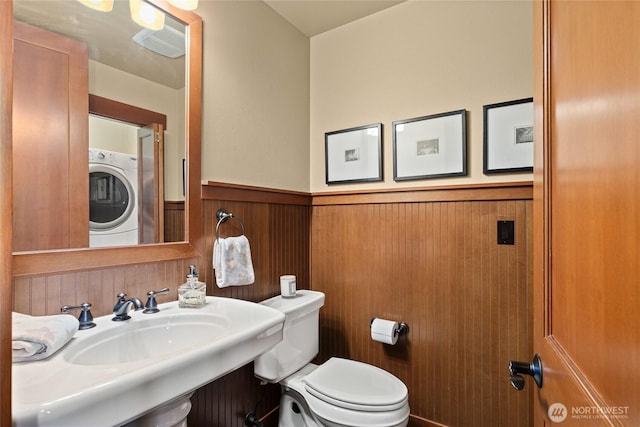 221 Cake Box Ln, Cle Elum, WA 98922 - bathroom with stacked washer / dryer and a wainscoted wall