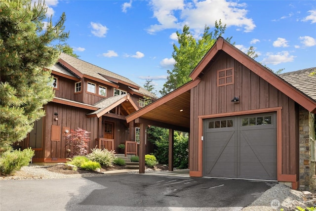 221 Cake Box Ln, Cle Elum, WA 98922 - chalet / cabin with roof with shingles, driveway, board and batten siding, and stone siding