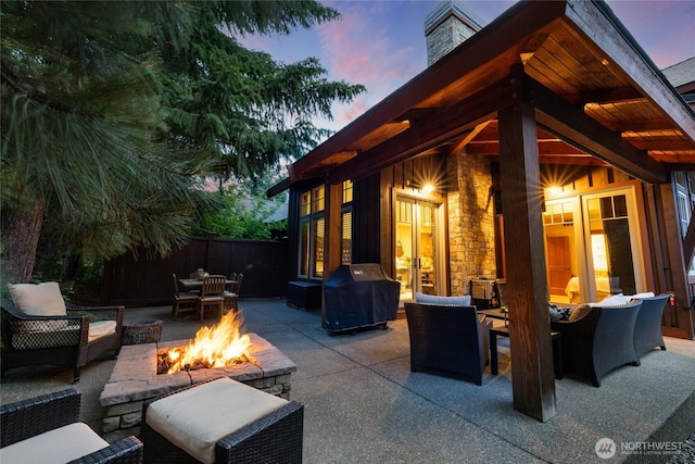 221 Cake Box Ln, Cle Elum, WA 98922 - patio terrace at dusk with grilling area, a patio, outdoor dining area, and an outdoor living space with a fire pit
