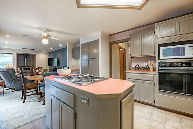 1117 W Racine St, Bellingham, WA 98229 - kitchen featuring black oven, white microwave, stainless steel electric cooktop, and gray cabinets