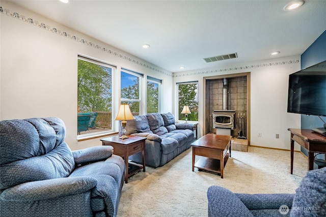 1117 W Racine St, Bellingham, WA 98229 - living room with a wood stove, light colored carpet, recessed lighting, and baseboards