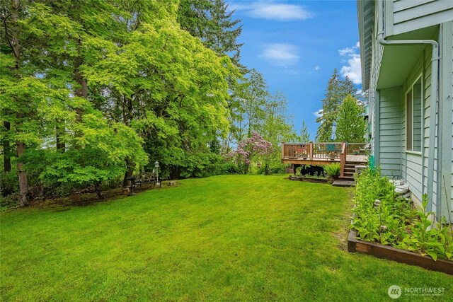 1117 W Racine St, Bellingham, WA 98229 - view of grassy yard with a wooden deck and a garden