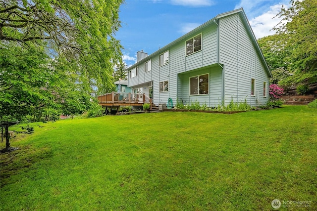 1117 W Racine St, Bellingham, WA 98229 - back of property featuring a chimney, a wooden deck, and a lawn