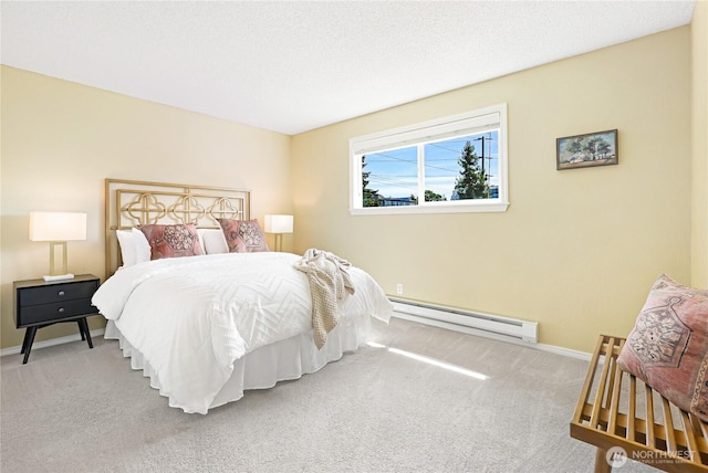 bedroom featuring baseboard heating, carpet floors, and baseboards