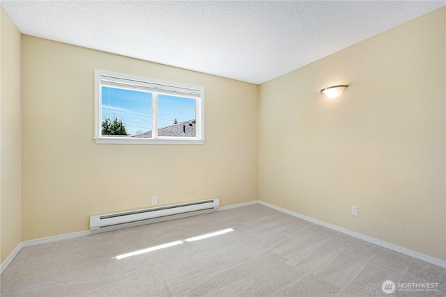 carpeted spare room featuring baseboard heating, baseboards, and a textured ceiling