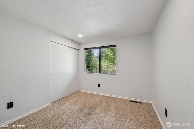 22434 SE Auburn-Black Diamond Rd, Black Diamond, WA 98010 - unfurnished bedroom featuring carpet floors, a closet, and a textured ceiling