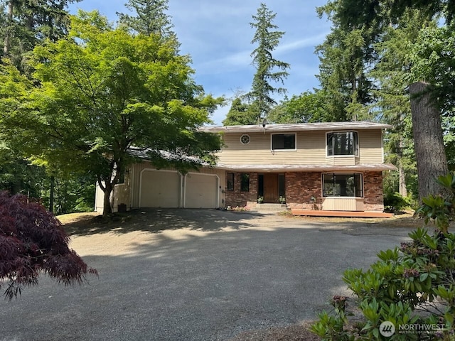 22434 SE Auburn-Black Diamond Rd, Black Diamond, WA 98010 - view of front facade featuring a garage, driveway, brick siding, and covered porch