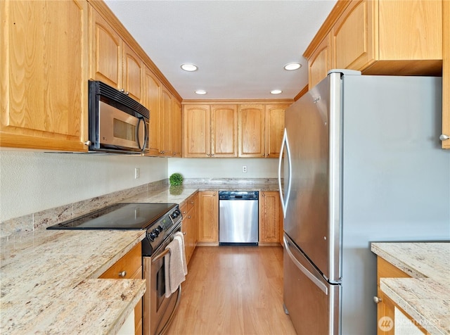 kitchen with appliances with stainless steel finishes, light wood-style floors, recessed lighting, light stone counters, and light brown cabinets