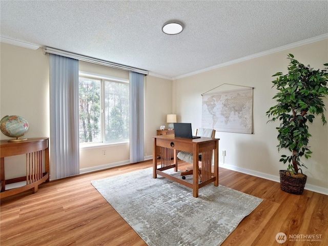 office with a textured ceiling, crown molding, light wood-style floors, and baseboards