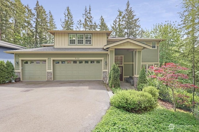 733 222nd Pl NE, Sammamish, WA 98074 - view of front of property featuring board and batten siding, stone siding, asphalt driveway, and an attached garage
