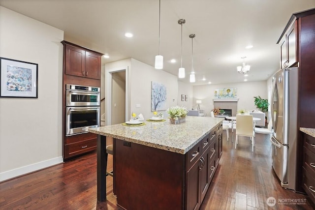 733 222nd Pl NE, Sammamish, WA 98074 - kitchen with stainless steel appliances, dark wood finished floors, baseboards, a center island, and recessed lighting