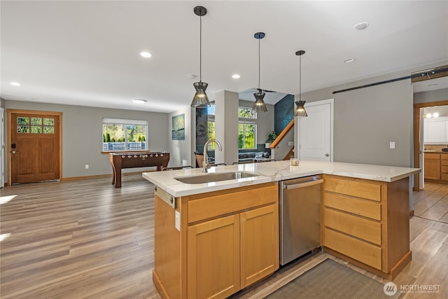 kitchen with a sink, open floor plan, stainless steel dishwasher, an island with sink, and recessed lighting