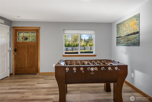 foyer with wood finished floors and baseboards