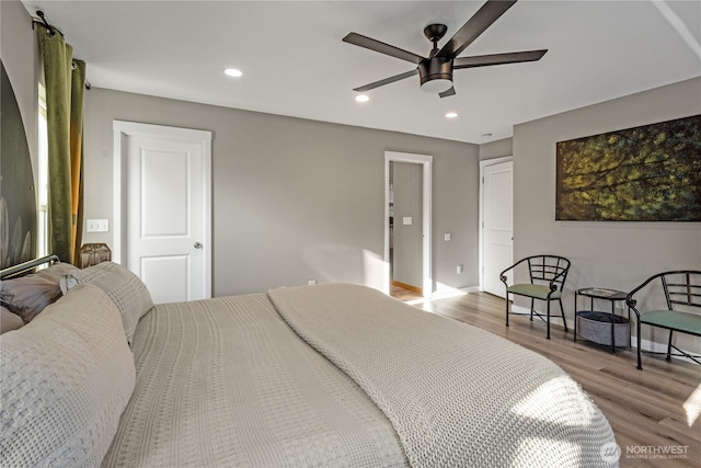 bedroom with wood finished floors, recessed lighting, baseboards, and ceiling fan