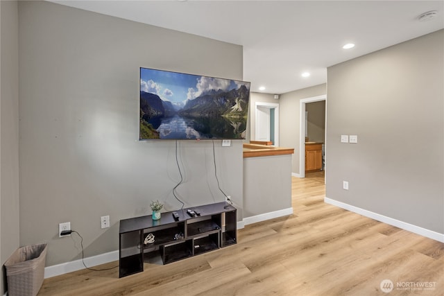 living room featuring wood finished floors, baseboards, and recessed lighting