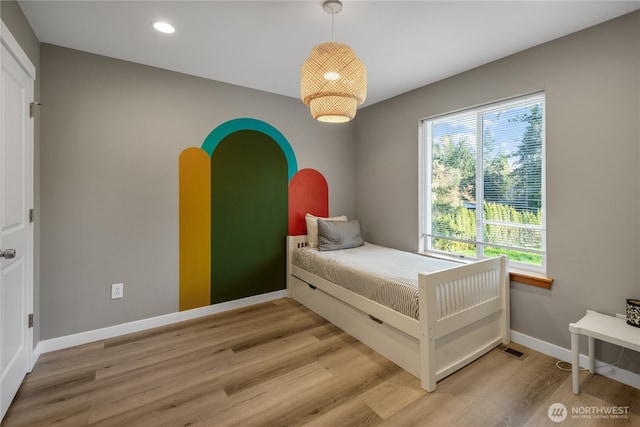 bedroom with wood finished floors, baseboards, and recessed lighting