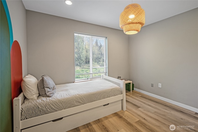 bedroom with wood finished floors, baseboards, and recessed lighting