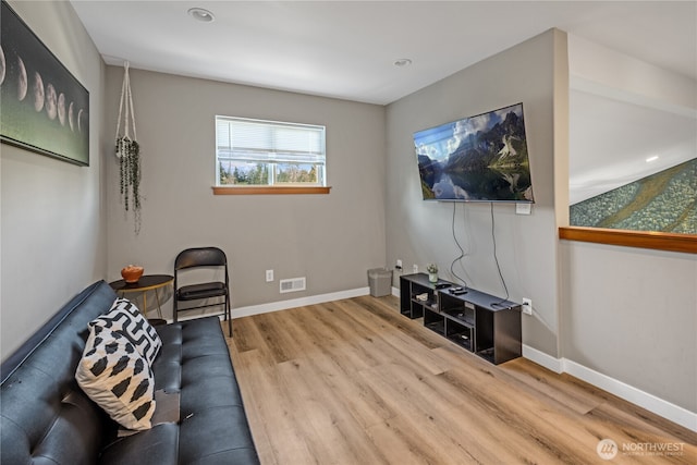 living area with wood finished floors, baseboards, and recessed lighting