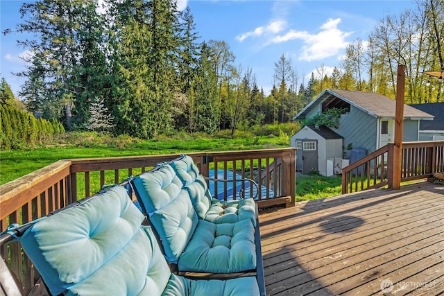 wooden deck featuring a storage unit and an outbuilding