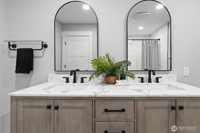 9371 Willamette Meridian Rd NW, Silverdale, WA 98383 - bathroom featuring a textured wall, double vanity, and curtained shower