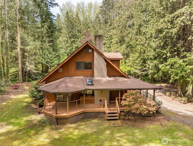 377 Stellar Ridge Ln, Sequim, WA 98382 - rear view of property featuring a chimney, a forest view, a lawn, and a shingled roof