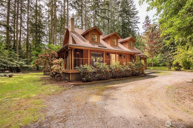 377 Stellar Ridge Ln, Sequim, WA 98382 - view of front of home featuring a chimney, driveway, a front yard, and covered porch