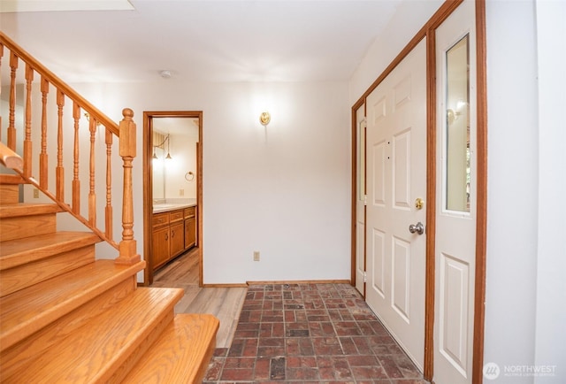 377 Stellar Ridge Ln, Sequim, WA 98382 - entrance foyer with baseboards, stairway, and brick patterned flooring