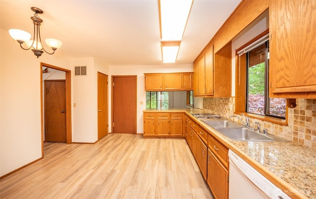 377 Stellar Ridge Ln, Sequim, WA 98382 - kitchen featuring white dishwasher, a sink, light countertops, and light wood finished floors