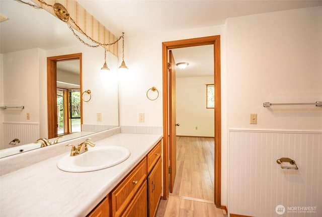 377 Stellar Ridge Ln, Sequim, WA 98382 - bathroom featuring wainscoting, wood finished floors, and vanity