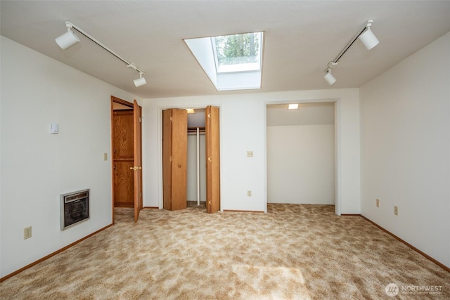 377 Stellar Ridge Ln, Sequim, WA 98382 - unfurnished bedroom with a skylight, track lighting, heating unit, and carpet floors