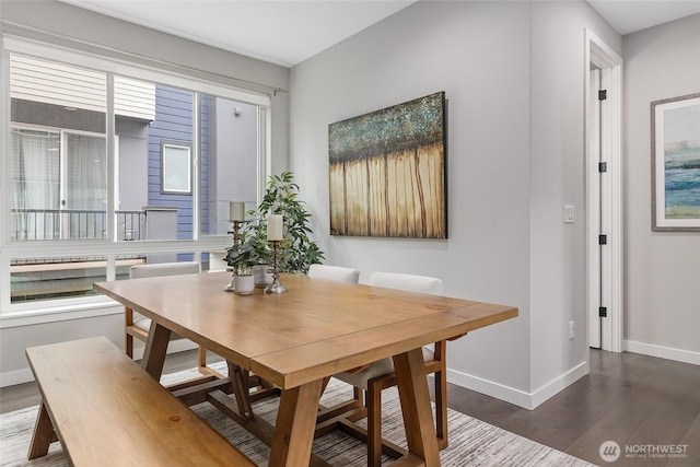 dining space featuring baseboards and wood finished floors