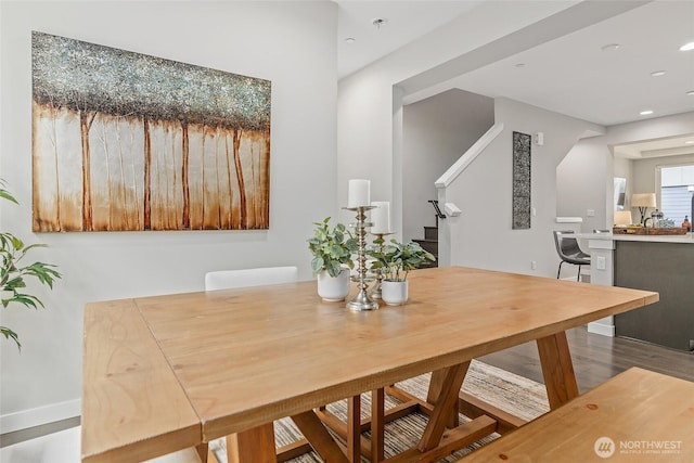 dining room with wood finished floors, recessed lighting, stairs, and baseboards