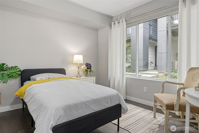 bedroom with baseboards and wood finished floors