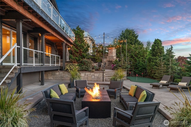 10326 66th Pl W, Mukilteo, WA 98275 - patio terrace at dusk with an outdoor living space with a fireplace