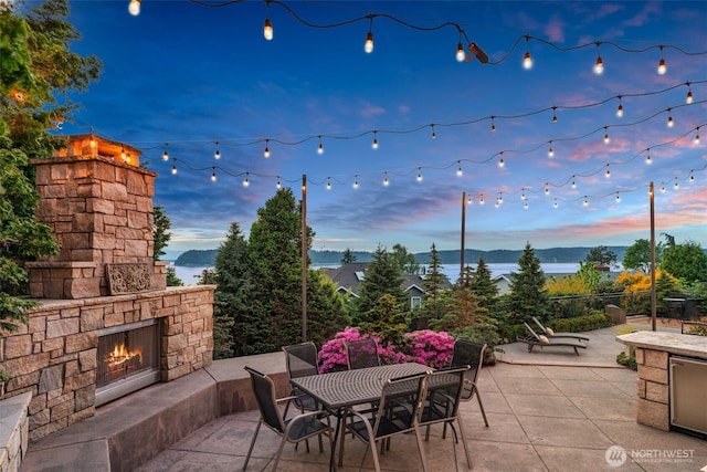 10326 66th Pl W, Mukilteo, WA 98275 - view of patio featuring an outdoor stone fireplace and outdoor dining space