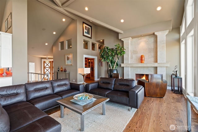10326 66th Pl W, Mukilteo, WA 98275 - living area with high vaulted ceiling, recessed lighting, light wood-style floors, plenty of natural light, and a tiled fireplace