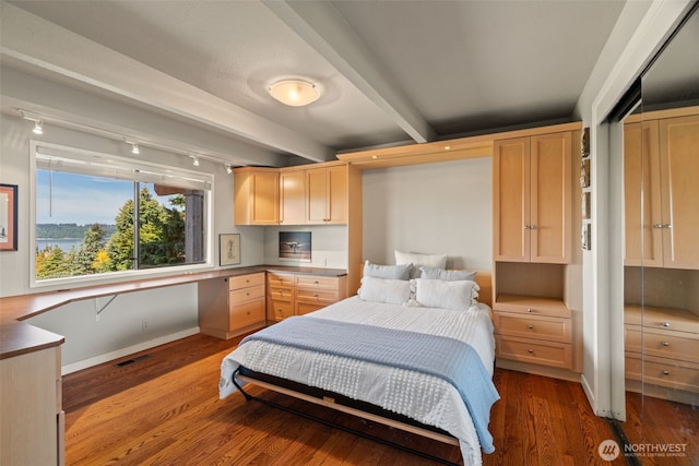 10326 66th Pl W, Mukilteo, WA 98275 - bedroom featuring beam ceiling, dark wood-style floors, built in desk, and baseboards