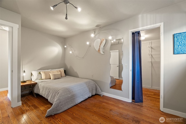 10326 66th Pl W, Mukilteo, WA 98275 - bedroom with wood finished floors, baseboards, and a walk in closet