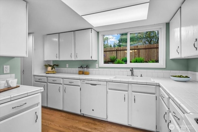 11725 NE 145th St, Kirkland, WA 98034 - kitchen featuring a sink, white dishwasher, white cabinetry, tile countertops, and light wood-style flooring