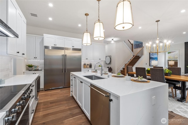 8232 21st Ave NE, Seattle, WA 98115 - kitchen featuring stainless steel appliances, a sink, a chandelier, decorative backsplash, and recessed lighting