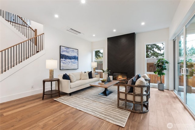 8232 21st Ave NE, Seattle, WA 98115 - living room with light wood-style flooring, plenty of natural light, stairway, recessed lighting, and baseboards