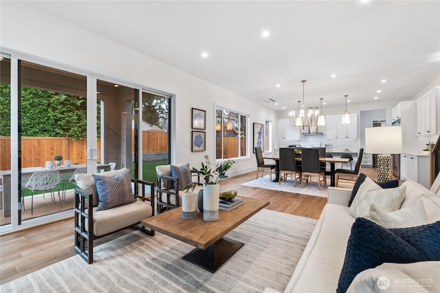 8232 21st Ave NE, Seattle, WA 98115 - living area with light wood-style flooring, recessed lighting, and a chandelier