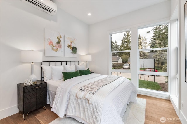 8232 21st Ave NE, Seattle, WA 98115 - bedroom with a wall mounted AC, wood finished floors, recessed lighting, and baseboards