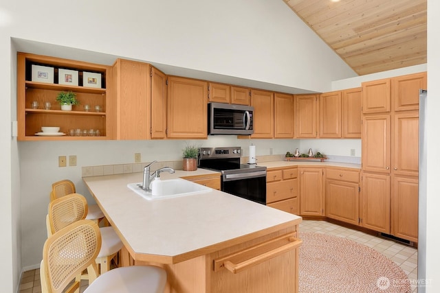 2847 Viewmont Pl, Camano Island, WA 98282 - kitchen with stainless steel appliances, a sink, lofted ceiling, light countertops, and a breakfast bar area