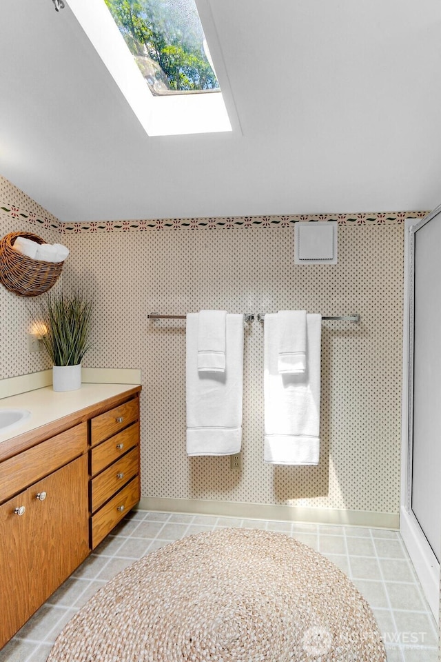 2847 Viewmont Pl, Camano Island, WA 98282 - bathroom featuring a shower stall, vanity, tile patterned flooring, and a skylight