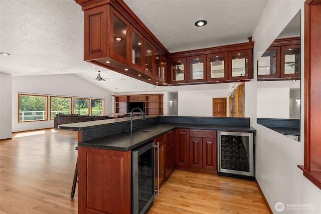139 Coulson Rd, Chehalis, WA 98532 - indoor bar with wine cooler, light wood-type flooring, vaulted ceiling, a textured ceiling, and baseboards