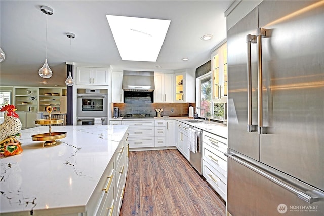 8612 NE 133rd St, Kirkland, WA 98034 - kitchen featuring stainless steel appliances, white cabinets, backsplash, light stone countertops, and recessed lighting